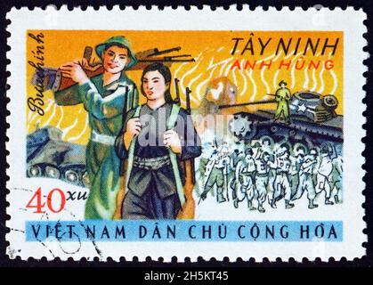 VIETNAM - UM 1969: Eine in Vietnam gedruckte Marke zeigt Aufständische und zerstörte US-Rüstungen, Tay Ninh, Sieg in Südvietnam, um 1969 Stockfoto