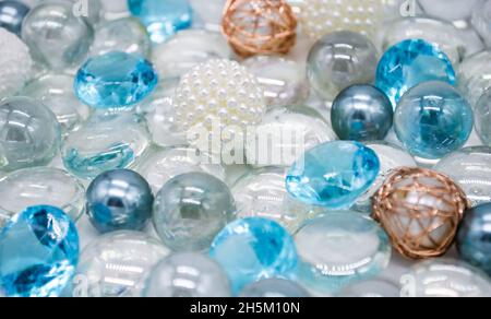 Schöner Hintergrund aus transparenten, hellblauen Glasperlen, Kristallen und weißen Perlen. Speicherplatz kopieren. Stockfoto