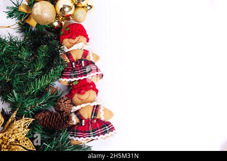 Weihnachtsarrangement mit Stoffspielzeug, goldenen Weihnachtskugeln und Kiefernzweigen Stockfoto