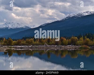 Blick auf das Südufer des Moose Lake im Mount Robson Provincial Park, British Columbia, Kanada mit bunten Bäumen, die sich im Wasser spiegeln. Stockfoto