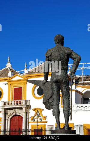 Die Stierkampfarena mit Matador-Statue im Vordergrund, Sevilla, Provinz Sevilla, Andalus Stockfoto