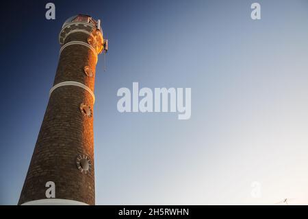 Der Leuchtturm José Ignacio wird während des Sonnenuntergangs, Maldonado, Uruguay, vom goldenen Licht der Sonne beleuchtet Stockfoto