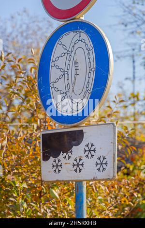 Schneeketten auf Reifen rutschige Straßenverkehrszeichen Winter Stockfoto