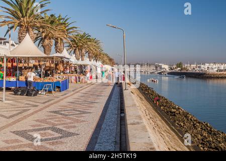 LAGOS, PORTUGAL - 6. OKTOBER 2017: Menschen gehen auf einer Uferpromenade in Lagos, Portugal. Stockfoto