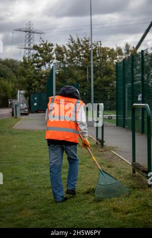 Community Payback Straftäter helfen in der Gemeinschaft durch Aufräumen und Aufräumen von Grünflächen und tun einige diy wie Malerei und Gartenarbeit. Stockfoto