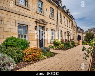 Bunte Straßenszene in der Lincolnshire-Stadt Stamford, die für ihre enge Straße mit buffigen Steingebäuden und georgianischer Architektur berühmt ist Stockfoto