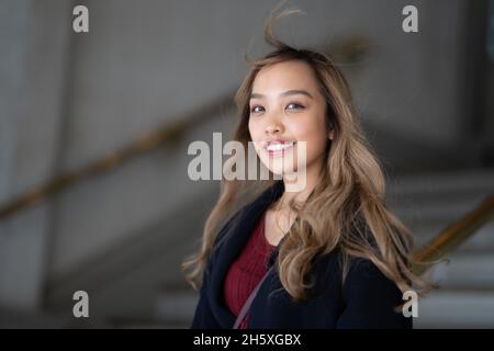 Nahaufnahme Porträt einer jungen lächelnden Filipina Frau im Herbst Kleiderschrank Stockfoto