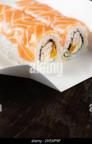 Philadelphia Rolle auf dem Teller für die Lebensmittelzustellung. Rollen Sie mit Lachs, Garnelen und Mango Stockfoto