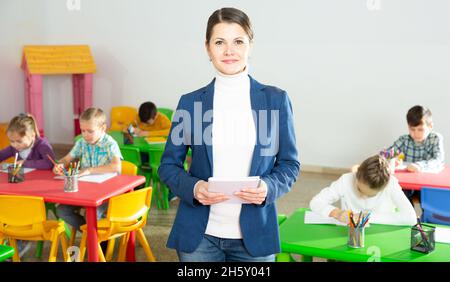 Lehrer im Klassenzimmer stehen lächelnd Stockfoto