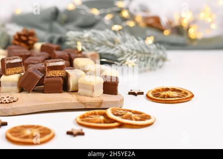 Deutsche Süßigkeiten genannt 'Dominosteine'. Weihnachtsbonbons bestehend aus Lebkuchen, Gelee und Marzipan-Schichten, die mit Schokoladenvereisung überzogen sind Stockfoto