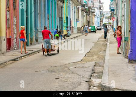 Ein Mann und eine Frau mit Fußgängern auf der Calle Neptuno im Zentrum von Havanna, La Habana (Havanna), Habana, Kuba Stockfoto