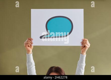 Frau hält einen blauen leeren Sprechballon aus Mockup-Papier oder eine Textnachricht hoch Stockfoto