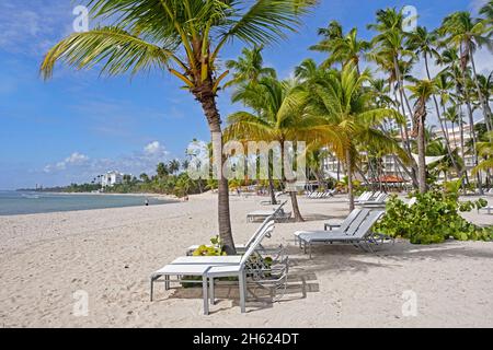 Leere Liegestühle am Strand Playa Hemingway in der Nähe von Juan Dolio, San Pedro de Macoris an der Südküste der Dominikanischen Republik, Hispaniola, Karibisches Meer Stockfoto