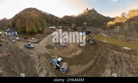 Altenahr, Deutschland. November 2021. Bauarbeiter nutzen schwere Geräte, um die beschädigte Zufahrtsstraße zum Tunnel auf der Bundesstraße 267 bei Altenahr zu reparieren (Luftaufnahme mit einer Drohne). Auch die Überschwemmungen im Ahrtal haben das Straßennetz verwüstet. Nach der Herstellung von provisorischen Lösungen wollen Experten es nun winterfest machen. (To dpa 'temporäre Straßen im Ahr-Hochwassergebiet werden überwintert') Quelle: Thomas Frey/dpa/Alamy Live News Stockfoto