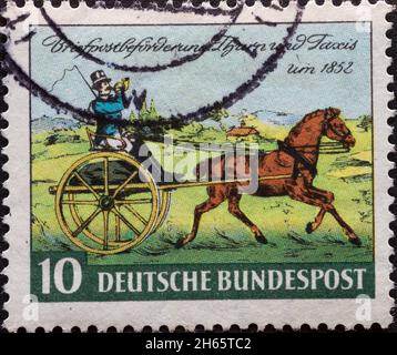 DEUTSCHLAND - UM 1952: Eine in Deutschland gedruckte Briefmarke, die ein Bild einer Pferdekutsche des Briefposttransports von Thurn und Taxis ar zeigt Stockfoto