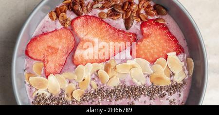 Frühstückssmoothie-Schüssel mit Chiasamen, Haferflocken, Mandeln und Erdbeeren. Gesundes Entgiftungskonzept Stockfoto