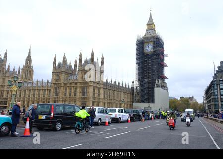 London, Großbritannien. November 2021. Dreihundert moderne und alte schwarze Taxis fahren am Remembrance Sunday auf der Länge der Westminster Bridge, um am jährlichen „Poppy Cabs“-Service teilzunehmen, der Veteranen kostenlose Fahrten zum Cenotaph-Gedenkgottesdienst in der Hauptstadt bietet. Schwarze Taxifahrer und Autoethnografen sind aus ganz London und dem Südosten angereist, um an einem seit 2009 laufenden Programm teilzunehmen. Kredit: Elfte Stunde Fotografie/Alamy Live Nachrichten Stockfoto