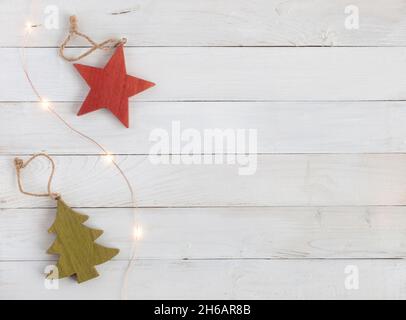 Neujahr Baumschmuck aus Holz und Girlande auf dem weißen Holzhintergrund, Draufsicht, Kopierraum Stockfoto