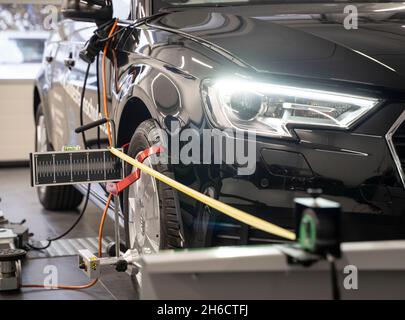 PRODUKTION - 12. November 2021, Hessen, Frankfurt/Main: Ein Teilnehmer des nationalen Wettbewerbs des Automobilhandels bringt in einer Werkstatt Ausrüstung an, um das Fahrzeug zur präzisen Einstellung der Fahrassistenzsysteme zu messen. Foto: Frank Rumpenhorst/dpa Stockfoto