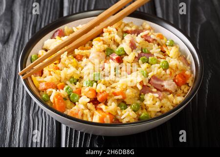 Chinesisches Ei gebratener Reis Yang Chow gebratener Reis in der Nähe auf dem Teller auf dem Tisch. Horizontal Stockfoto