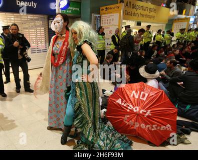 Im Terminal 1 des Flughafens Heathrow fand ein Protest gegen eine dritte Start- und Landebahn statt. Hunderte von Demonstranten kamen in edwardianischem Kleid mit Esskrümmen an, um ein „Abendessen bei den Inlandsabfahrten“ zu genießen. Stockfoto