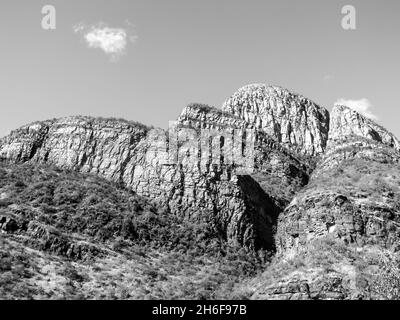 Die hohen, steilen Bergklippen, die den Abel Erasmus Pass von Südafrika in Schwarz-Weiß umgeben Stockfoto