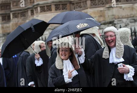 Eine Prozession von Richtern, die im Regen in Westminster London abgebildet sind, während sie an einem Gottesdienst in der Westminster Abbey anlässlich des juristischen Jahres teilnehmen Stockfoto