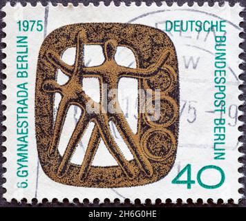 DEUTSCHLAND, Berlin - UM 1975: Eine Briefmarke aus Deutschland, Berlin mit einem Veranstaltungs-Abzeichen der Gymnaestrada Berlin Stockfoto