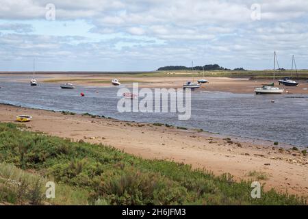 Brunnen neben dem Meer, Boote in den Kanal, die zum Meer laufen, Norfolk, vertäut. Stockfoto