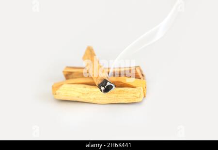 Palo Santo oder ein Satz von heiligen Baumstämmen, die mit Duftrauch brennen. Meditation, spirituelle Praktiken, reinigtes Energiekonzept Stockfoto