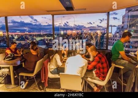 MADRID, SPANIEN - 22. OKTOBER 2017: Menschen in der Bar im El Corte Ingles Gebäude beobachten einen Sonnenuntergang in Madrid Stockfoto