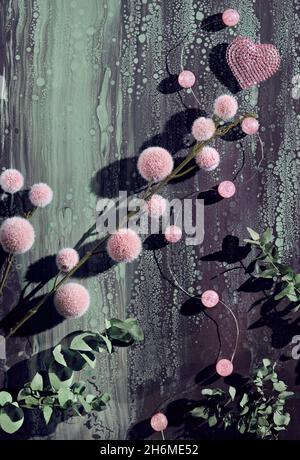 Flauschige Weihnachten Hintergrund. Fuzzy weichen rosa Kugeln mit Eukalyptuszweigen auf abstrakten flüssigen Acryl gegossen Hintergrund in dunkel und hellgrün. Stockfoto