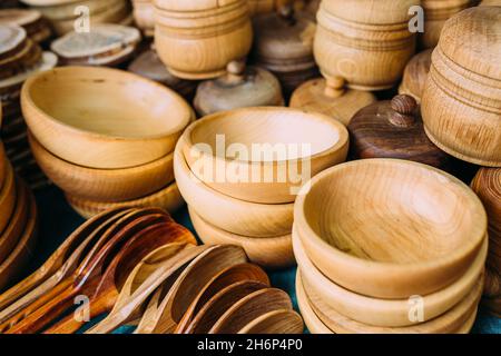 Handgemachtes Holzgeschirr auf der Theke. Umweltfreundliche Löffel und Teller Stockfoto