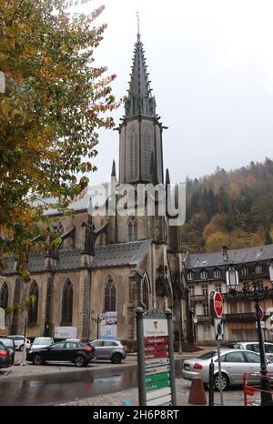 PLOMBIERES-LES-BAINS, FRANKREICH, 4. NOVEMBER 2021: Blick auf das Stadtzentrum und Parkplatz an der Kirche St. Amé in Plombieres. Plombieres ist ein Kurort an Stockfoto