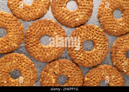 Mehrere frisch gebackene Kekse mit Nüssen auf einem Metalltablett, Nahaufnahme, Draufsicht. Stockfoto