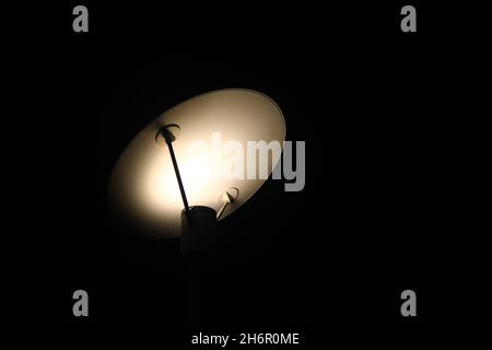 Die Schatten der Lichter einer Designlampe in der Nacht auf der Straße Stockfoto