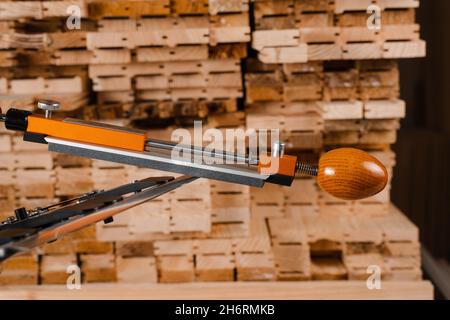 Schärfen Messer Prozess mit professionellen Spitzer mit Wetzstein in der Werkstatt Stockfoto