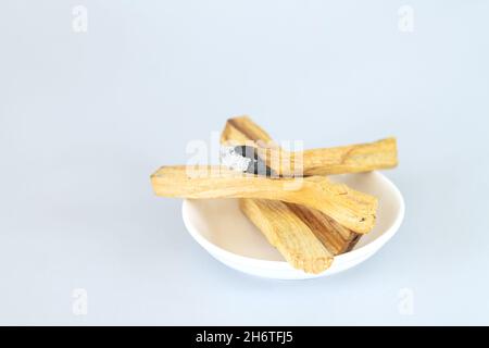 Palo santo heiliges Holz auf weißer Keramikplatte. Konzept der Meditation, Heilung, spirituellen Praktiken Stockfoto