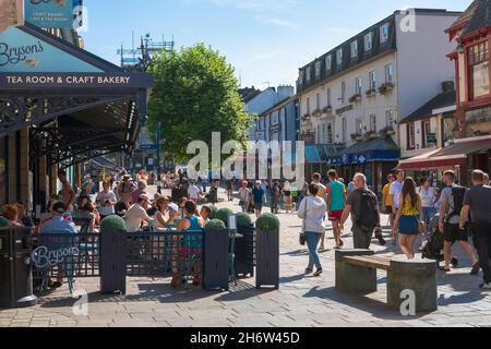 Keswick Cumbria, Blick auf einen Sommertag, an dem Leute einkaufen oder sich an Cafés in der Main Street, Keswick, Cumbria, England, entspannen Stockfoto