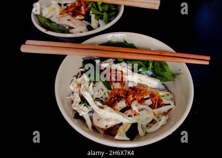 Banh UOT Long GA, einzigartige vietnamesische trockene Reisnudeln (flach und breit wie nasse Reiskuchennudeln), gemischt mit Kräutern und Fleisch, eine lokale Delikatesse von Da Stockfoto