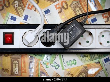 Mehrfachsteckdose mit drei angeschlossenen elektrischen Geräten. Energiekostenfalle. Stockfoto