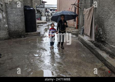 Am 19. November 2021 regnete es an einem regnerischen Tag auf der Straße im Flüchtlingslager Rafah im südlichen Gazastreifen. Stockfoto