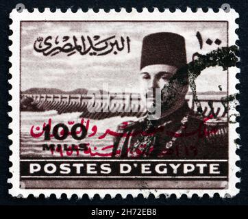 ÄGYPTEN - UM 1949: Eine in Ägypten gedruckte Marke zeigt König Farouk von Ägypten und den Assuan-Staudamm, um 1949 Stockfoto