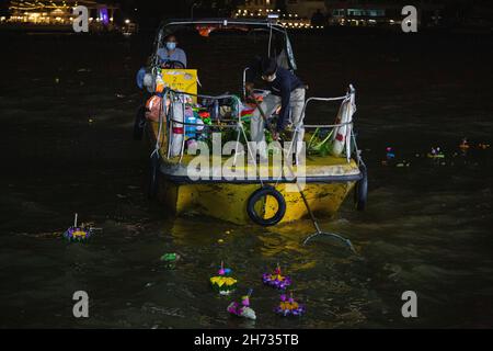 Bangkok, Thailand. 19th. November 2021. Die Mitarbeiter der Metropole Bangkok sahen während des Festivals auf einem Boot, wie sie Geschenke von Kra Thong vom Fluss sammelten.Nachdem sie alle Ereignisse aufgrund der COVID-19-Pandemie fast 2 Jahre lang gesperrt und abgesagt hatten, wurde schließlich das im vergangenen Jahr zurückgebrannte Loy-Krathong-Festival organisiert. Das Festival wird jährlich in Thailand und in den umliegenden Ländern gefeiert. KRA Thong ist ein Angebot, der Göttin des Wassers zu danken und „Loy“ bedeutet zu schweben. Kredit: SOPA Images Limited/Alamy Live Nachrichten Stockfoto