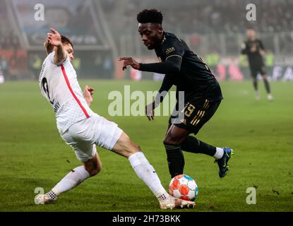 Augsburg, Deutschland. 19th. November 2021. Alphonso Davies (R) von Bayern München steht am 19. November 2021 in Augsburg bei einem Bundesliga-Spiel zwischen dem FC Augsburg und dem FC Bayern München mit Robert Gumny aus Augsburg auf dem Spiel. Quelle: Philippe Ruiz/Xinhua/Alamy Live News Stockfoto