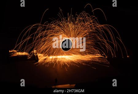 Nachtfeuertanz. Funken aus Stahlwolle auf schwarzem Hintergrund. Nahaufnahme. Stockfoto