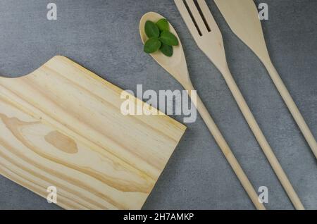 Holzbesteck auf grauem Hintergrund. Stockfoto