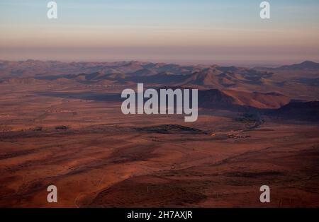 Der Blick von einem Heißluftballon hinunter in die Wüste und Dörfer in der Nähe von Marrakesch, Sonnenaufgang im April, Marokko Stockfoto