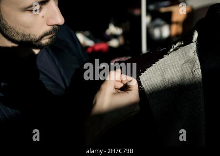 Maßgeschneiderte Arbeit mit maßgeschneiderten Anzug. Konzept der Mode, handgefertigt Stockfoto