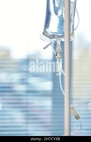 Nahaufnahme des Infusionsschlauchs. Aktion. Dropper mit Medikament tropft langsam in den Schlauch. Intravenöse Röhrchen für kranke Patienten nach der Operation Stockfoto